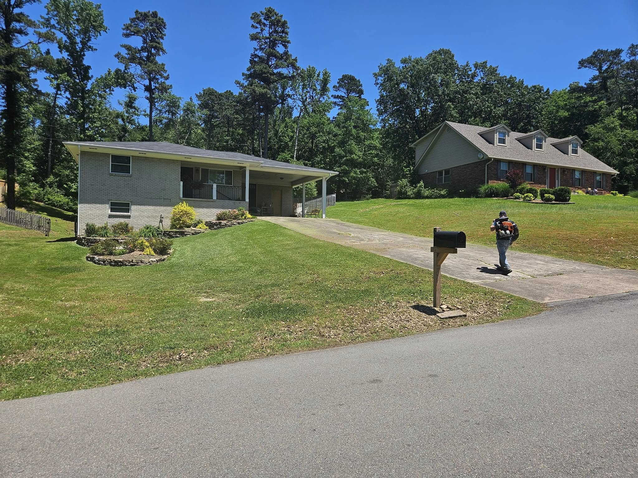 Worker on site of a cleanly maintained yard 