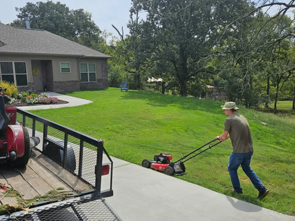 Worker on site mowing lawn